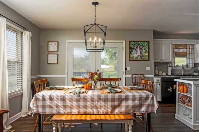 dining room with a chandelier, dark hardwood / wood-style flooring, a wealth of natural light, and sink