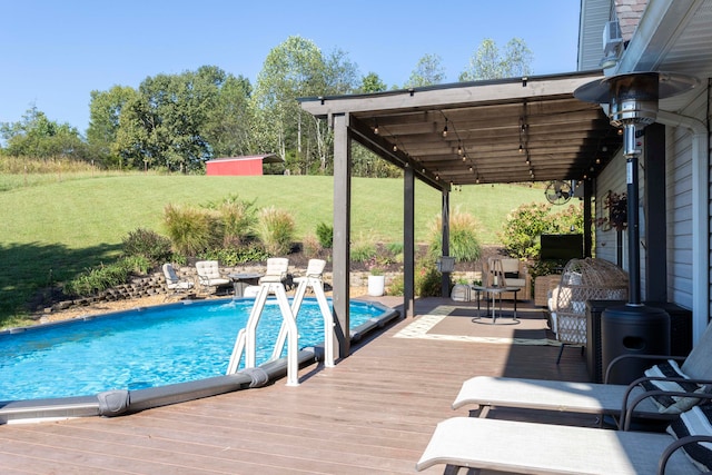 view of pool with a lawn and a deck