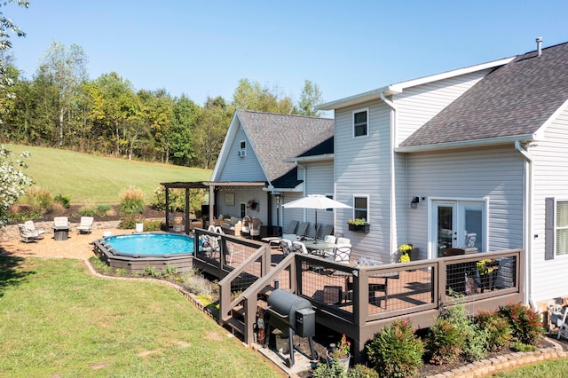 back of house with a yard and a pool side deck