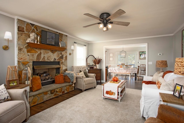 living room featuring dark hardwood / wood-style flooring, a wealth of natural light, and crown molding