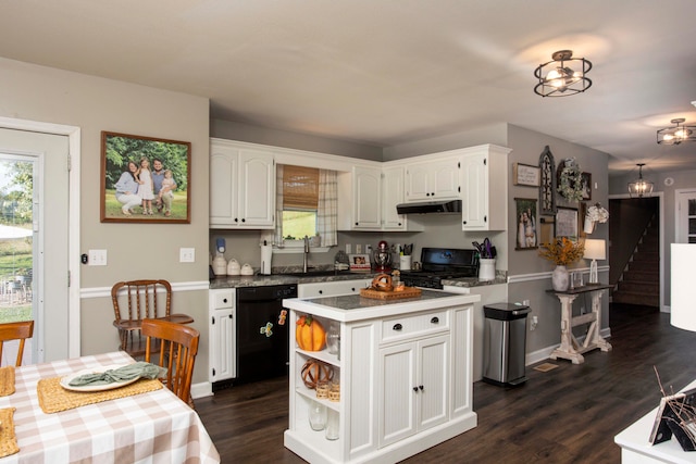 kitchen with a center island, dark hardwood / wood-style floors, white cabinetry, and black appliances