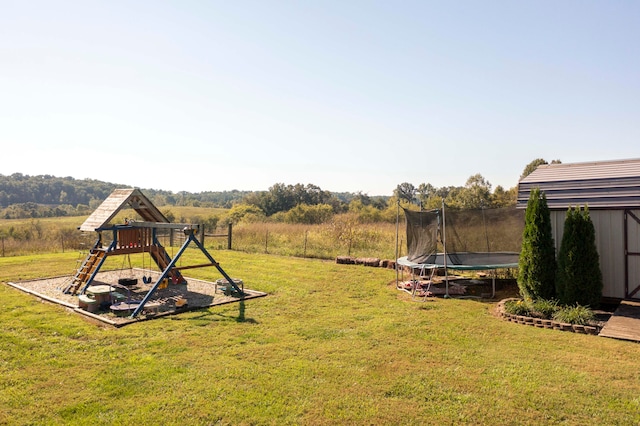 view of yard featuring a playground, a shed, and a trampoline