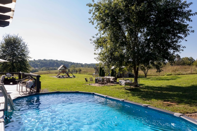 view of pool with a yard