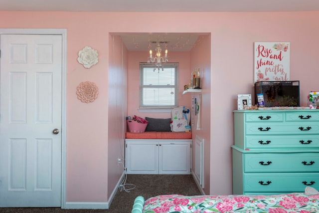 bedroom with a chandelier and dark colored carpet