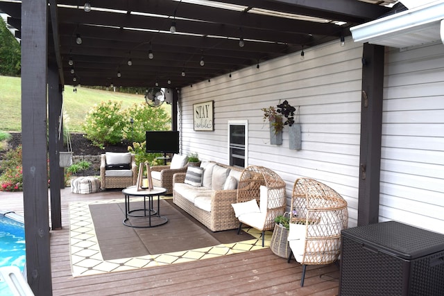 wooden terrace with a swimming pool and an outdoor hangout area