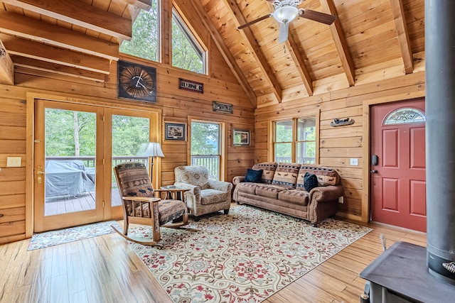 living room with wood ceiling, wooden walls, and light hardwood / wood-style floors