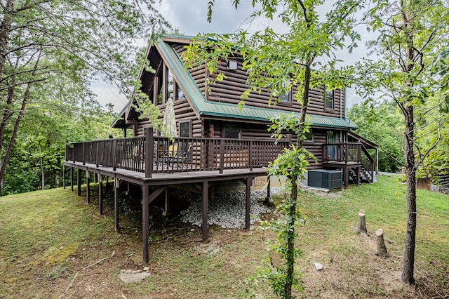 back of property featuring central AC unit, a yard, and a wooden deck