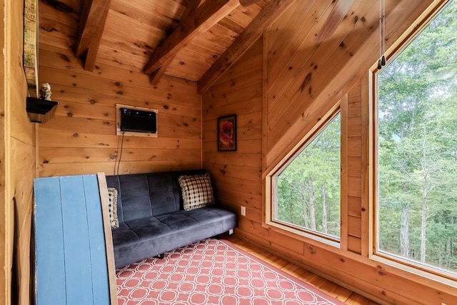 unfurnished room featuring lofted ceiling with beams, wood-type flooring, wooden walls, and wooden ceiling