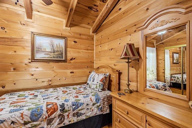 bedroom featuring lofted ceiling with beams, ceiling fan, wooden walls, and wood ceiling