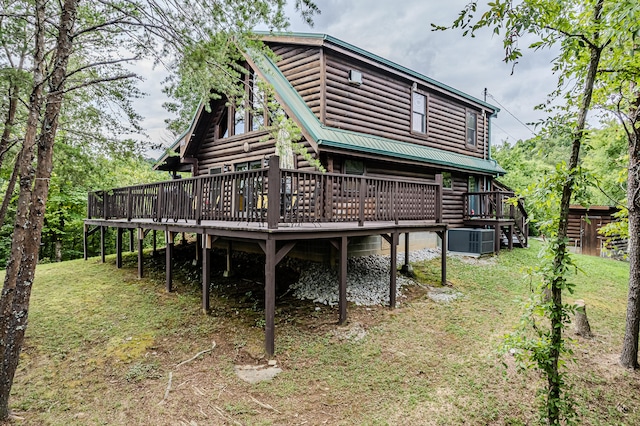 back of house with a deck, central AC unit, and a lawn