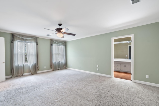 unfurnished room featuring crown molding, ceiling fan, and light colored carpet