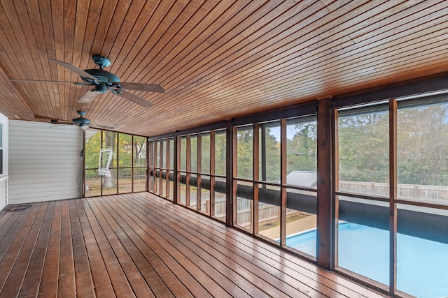 unfurnished sunroom featuring ceiling fan and wood ceiling