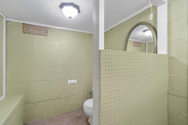 bathroom with tile patterned flooring, toilet, and crown molding