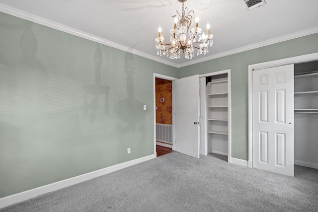 unfurnished bedroom with carpet floors, crown molding, multiple closets, and a notable chandelier