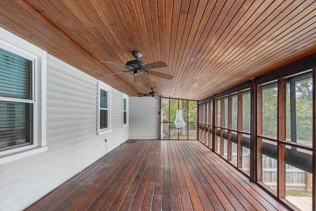 unfurnished sunroom with ceiling fan and wood ceiling