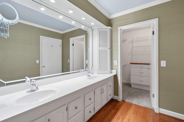 bathroom featuring vanity, hardwood / wood-style flooring, and crown molding