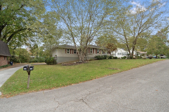 ranch-style home with a front yard