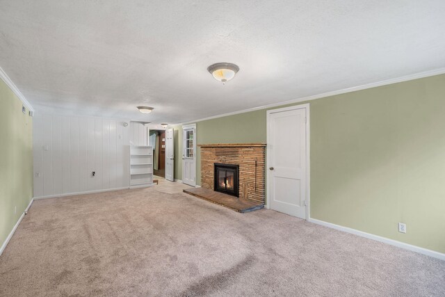 unfurnished living room with crown molding, carpet, and a textured ceiling