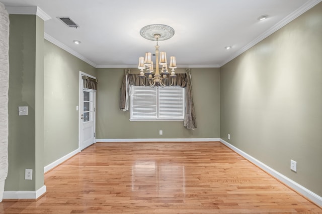 unfurnished room with light hardwood / wood-style floors, crown molding, and a notable chandelier