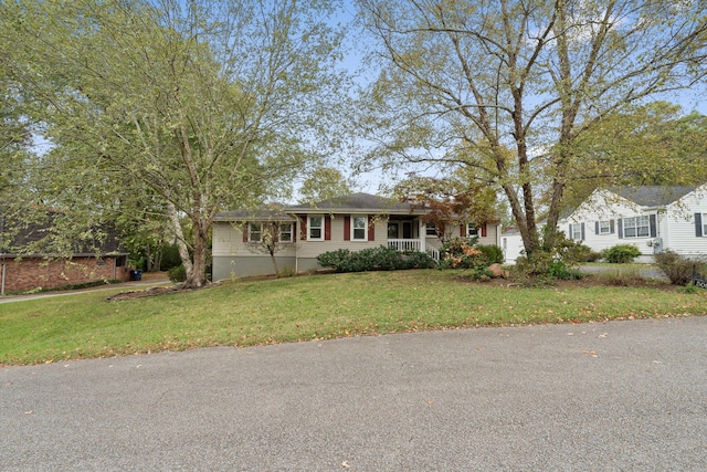 single story home with covered porch and a front yard