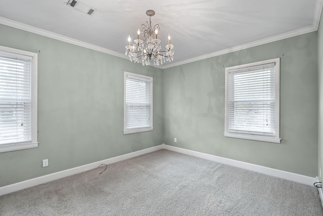 spare room featuring a chandelier, carpet flooring, and a wealth of natural light