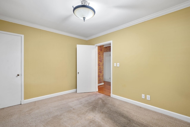 carpeted spare room with crown molding