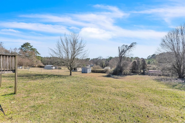 view of yard featuring a rural view and fence