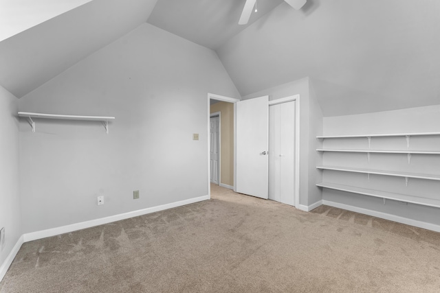 bonus room with vaulted ceiling, ceiling fan, carpet, and baseboards