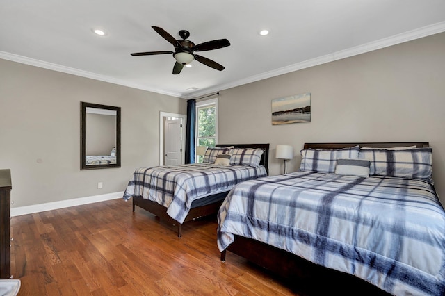 bedroom with ceiling fan, wood-type flooring, and ornamental molding