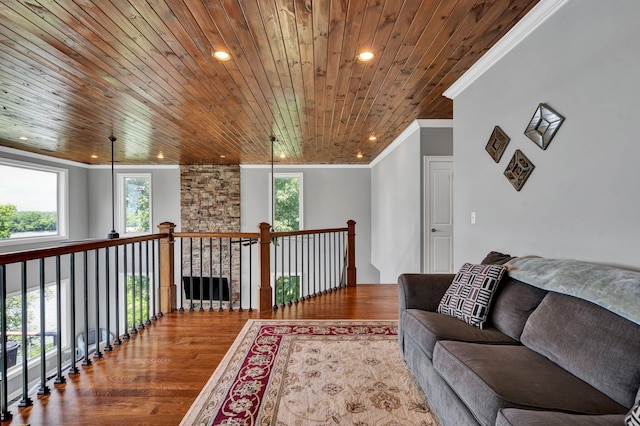 interior space with hardwood / wood-style flooring, crown molding, and wooden ceiling