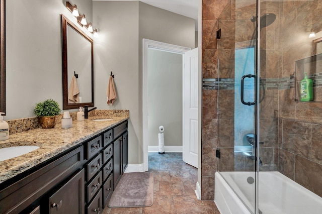 bathroom with shower / bath combination with glass door and vanity