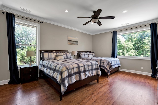 bedroom with ceiling fan, dark wood-type flooring, and multiple windows