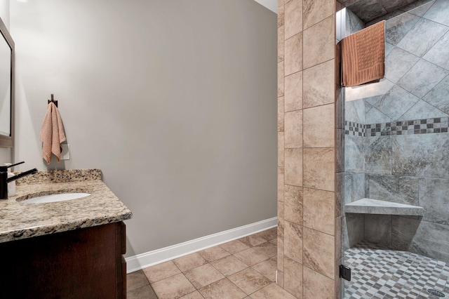 bathroom with tile patterned floors, vanity, and a shower with door