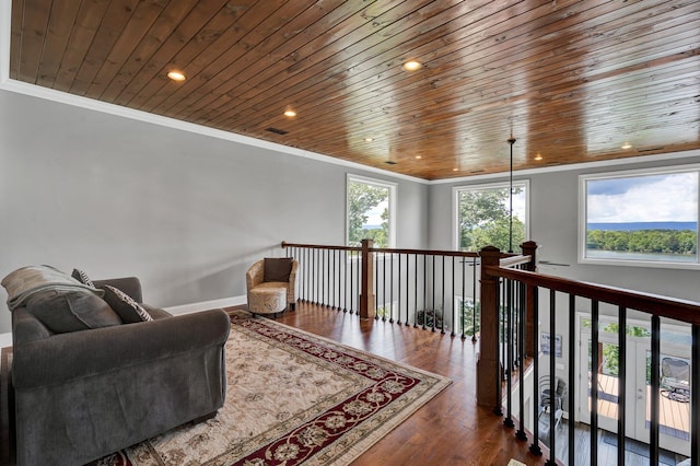 sitting room featuring ornamental molding, dark wood-type flooring, and wooden ceiling