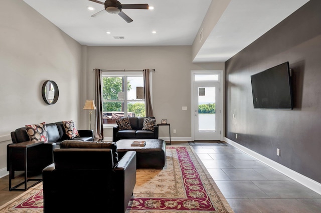 tiled living room featuring ceiling fan