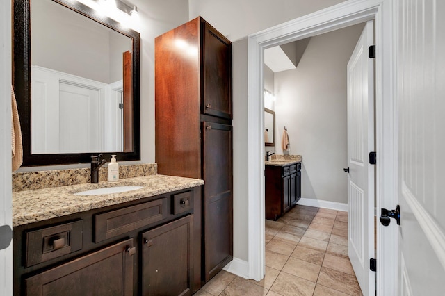 bathroom featuring tile patterned flooring and vanity