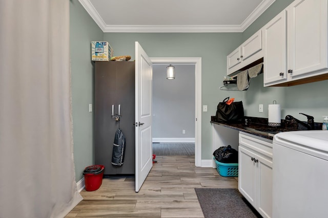 kitchen featuring white cabinets, light hardwood / wood-style flooring, crown molding, and sink