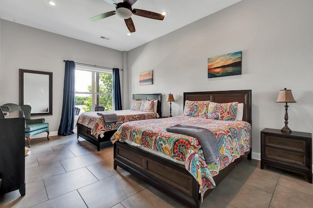 bedroom with ceiling fan and light tile patterned floors