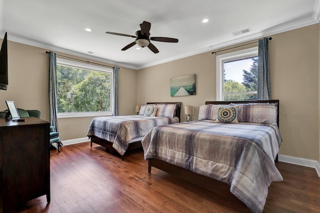 bedroom with ceiling fan, dark hardwood / wood-style floors, crown molding, and multiple windows