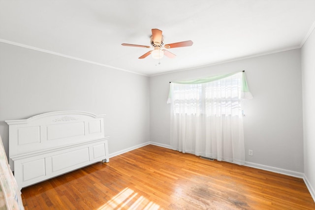 unfurnished room with light wood-type flooring, ceiling fan, and crown molding