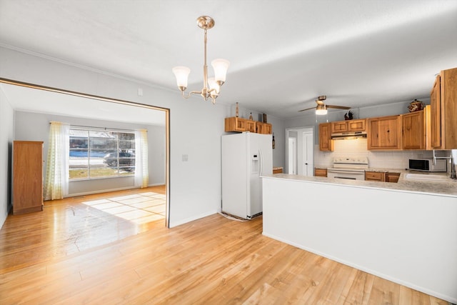 kitchen with decorative light fixtures, backsplash, white appliances, light hardwood / wood-style flooring, and ceiling fan with notable chandelier