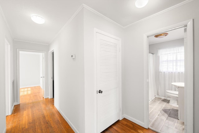 hallway featuring crown molding and hardwood / wood-style flooring