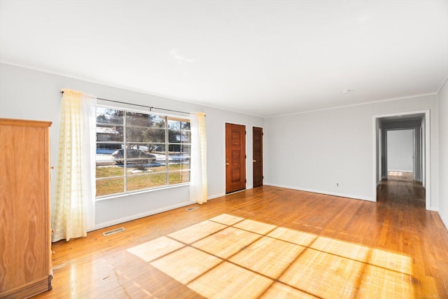 spare room with hardwood / wood-style flooring