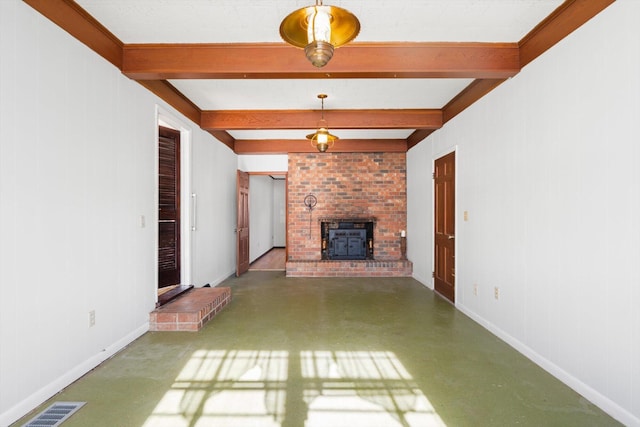 unfurnished living room featuring beamed ceiling