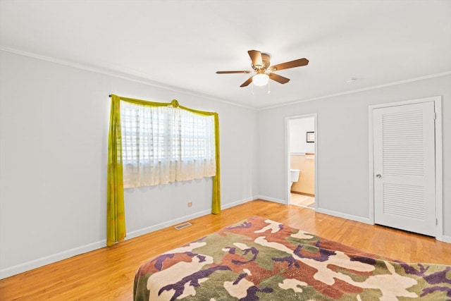 bedroom featuring ceiling fan, ornamental molding, and hardwood / wood-style flooring