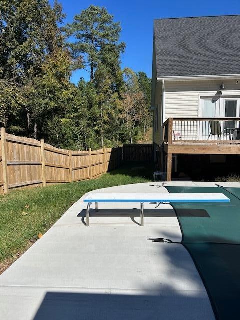 view of pool featuring ceiling fan and a wooden deck