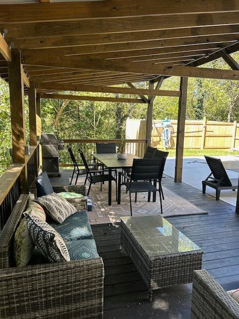 wooden deck featuring a grill and an outdoor hangout area