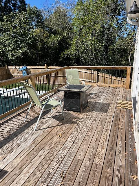 wooden deck with an outdoor fire pit