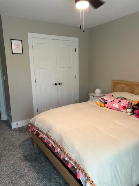 bedroom featuring ceiling fan, a closet, and carpet