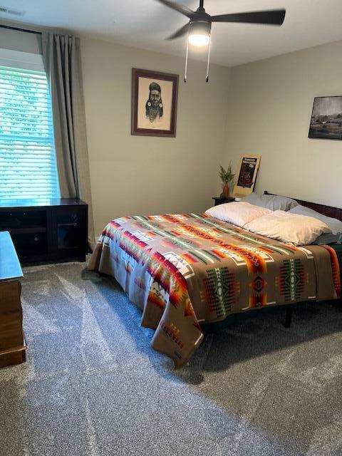 carpeted bedroom featuring ceiling fan